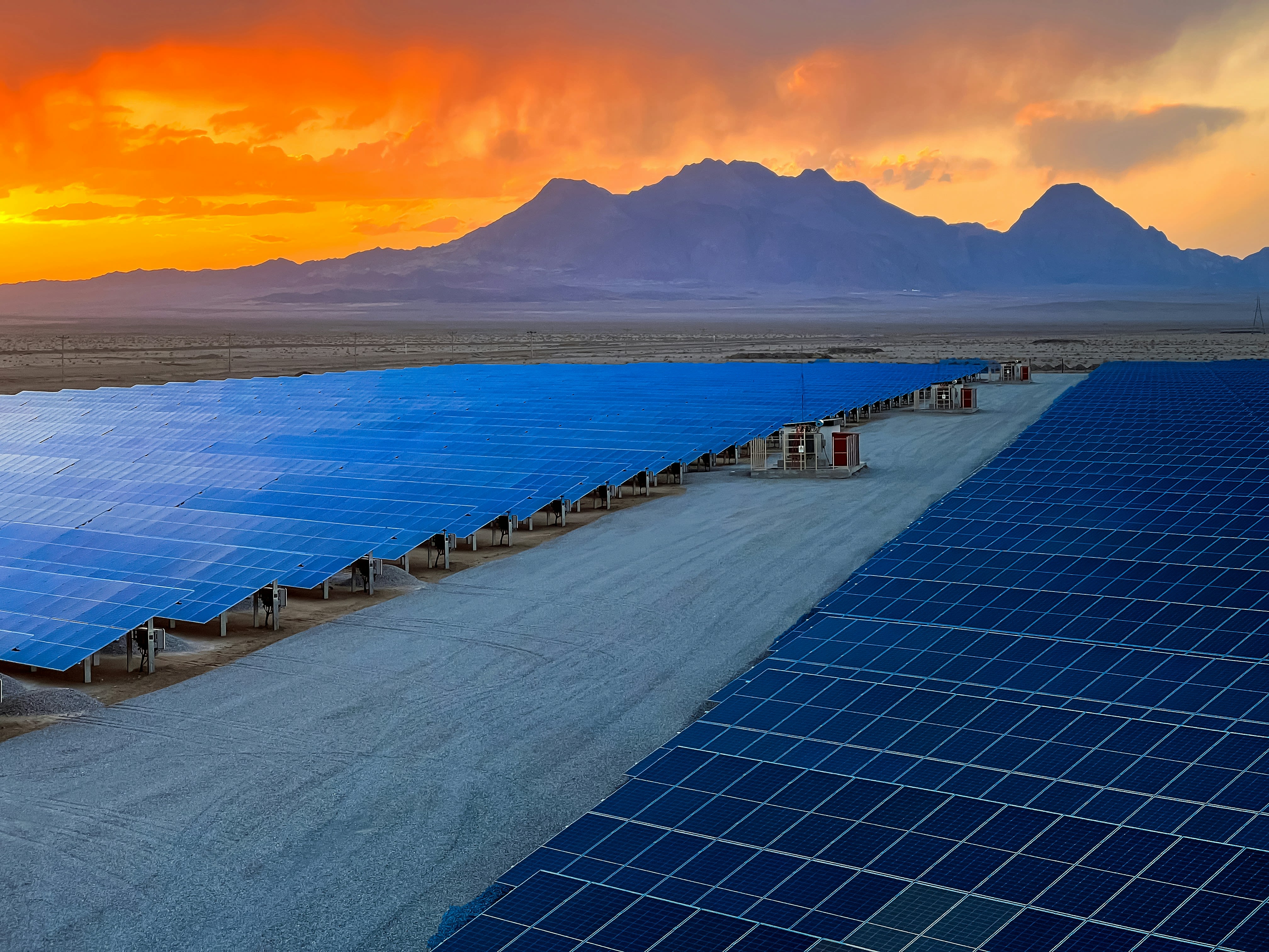 a large array of solar panels in a desert