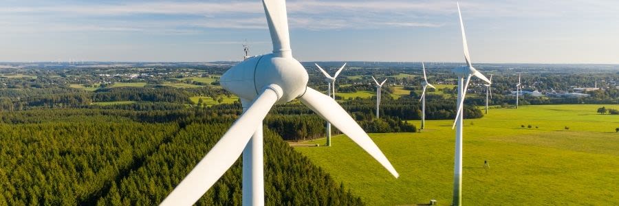 Windmills with green grass and blue sky
