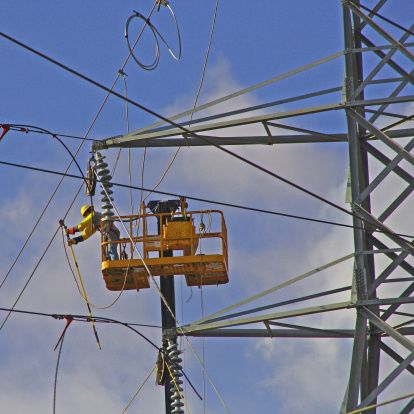 man wearing red hard hat hanged on brown rebar bar